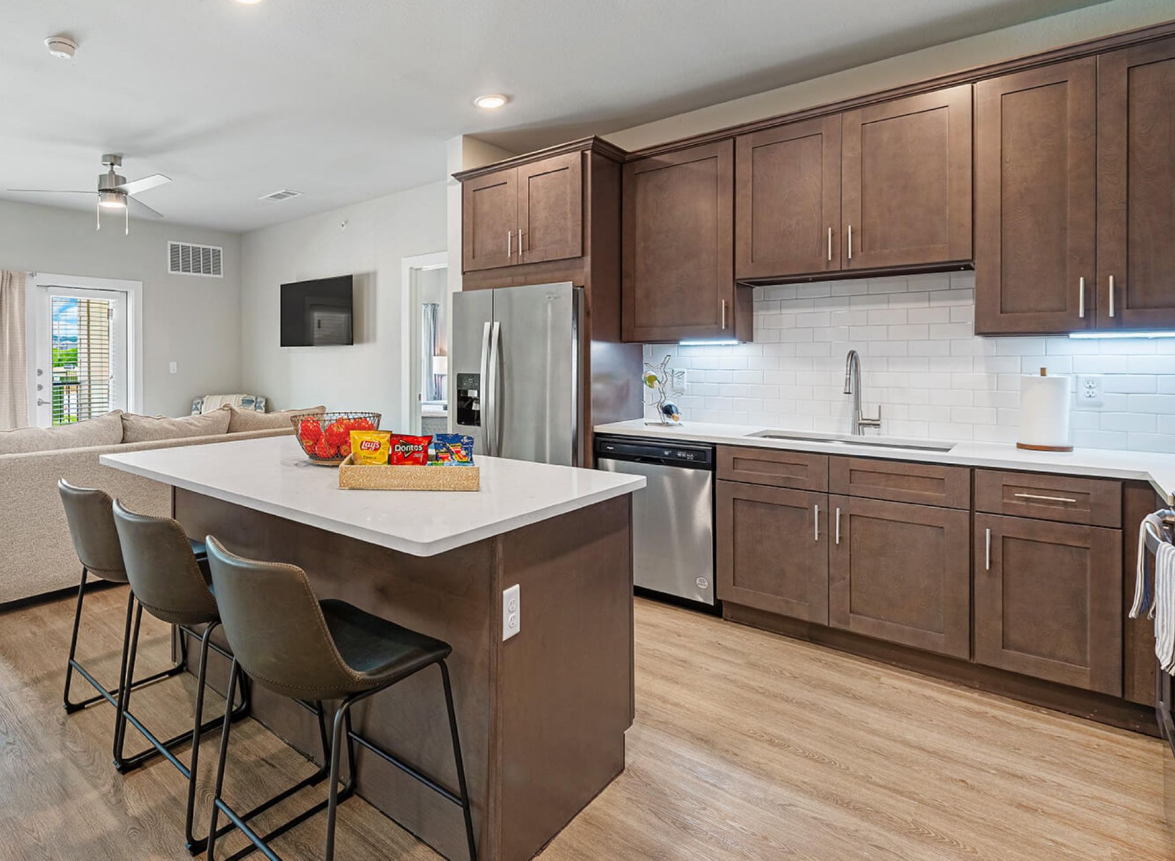 Luxury apartment kitchen with stainless steel appliances, granite countertops, and lots of storage space