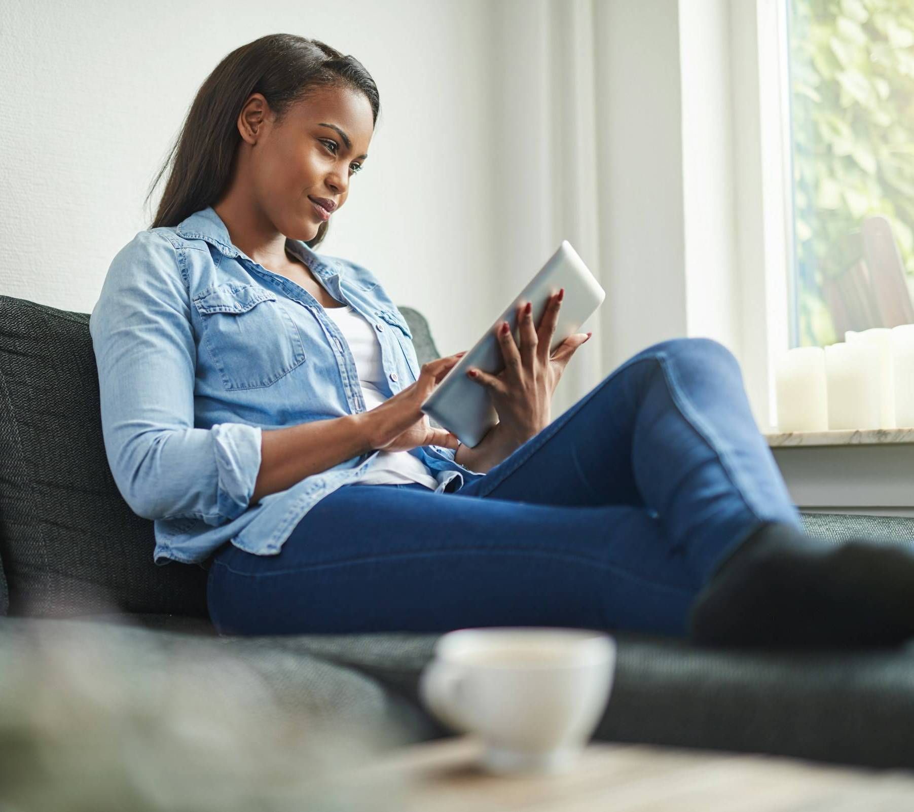 The Delta Pearland in Pearland, TX with a young woman reading a book on a couch