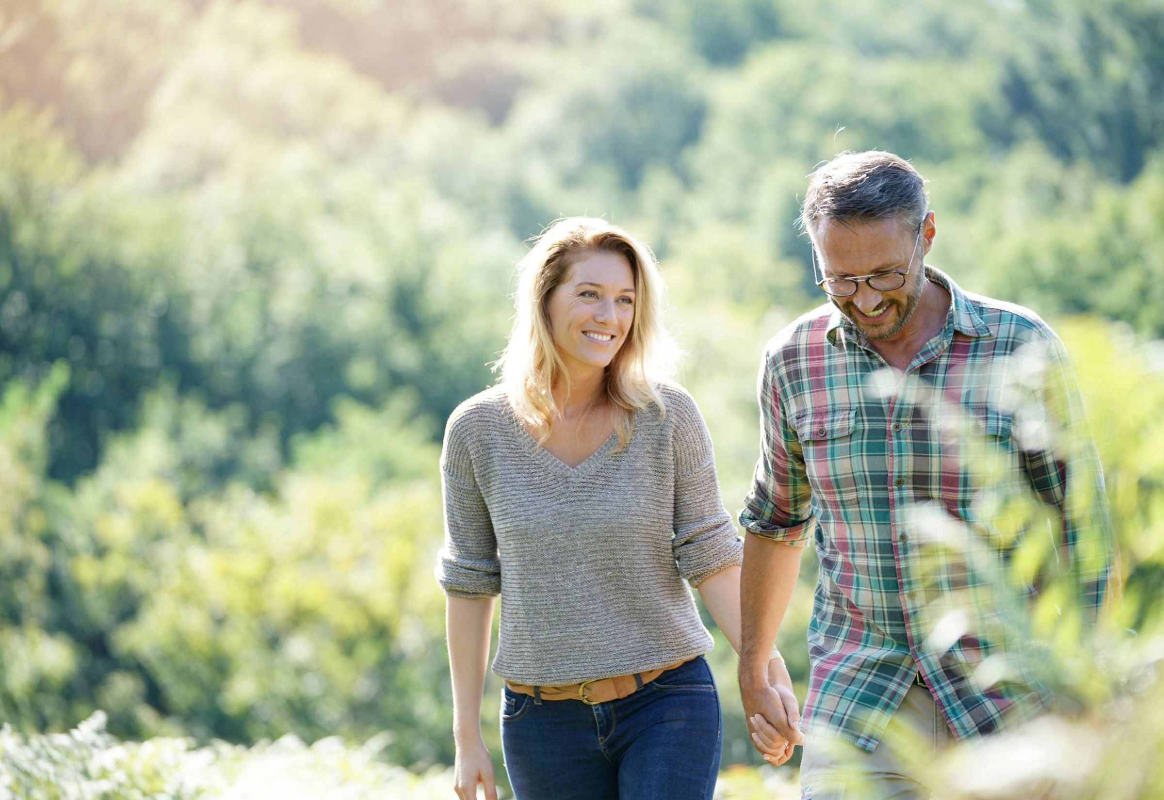 The Delta Pearland luxury apartments in a Texas neighborhood with a happy couple on a nature walking trail